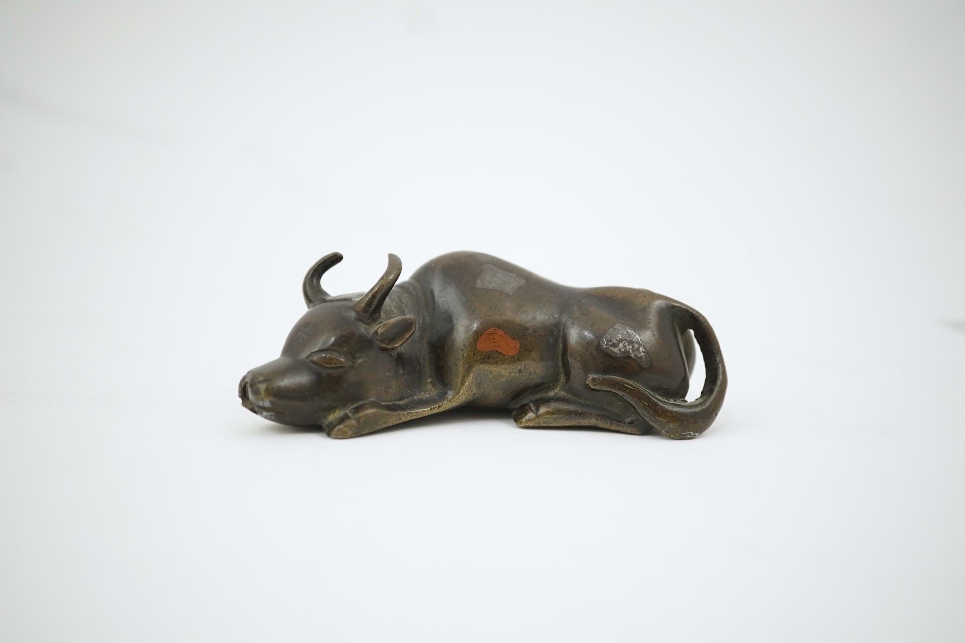 A Chinese bronze and mixed metal buffalo scroll weight, 19th century